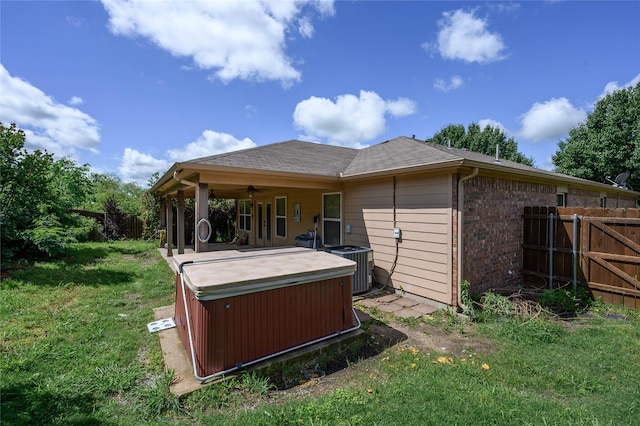 1443 Teal, Sherman, TX 75092 - back of house with a hot tub, ceiling fan, central AC unit, and brick siding