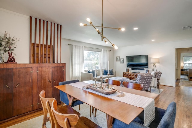 dining room featuring a chandelier, light wood-type flooring, and recessed lighting