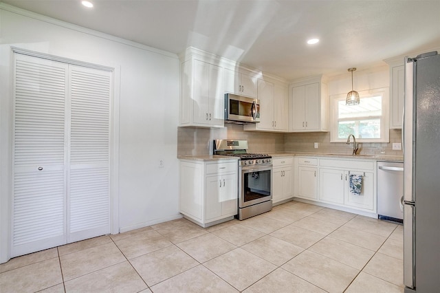 kitchen featuring stainless steel appliances, a sink, tasteful backsplash, white cabinets, and recessed lighting