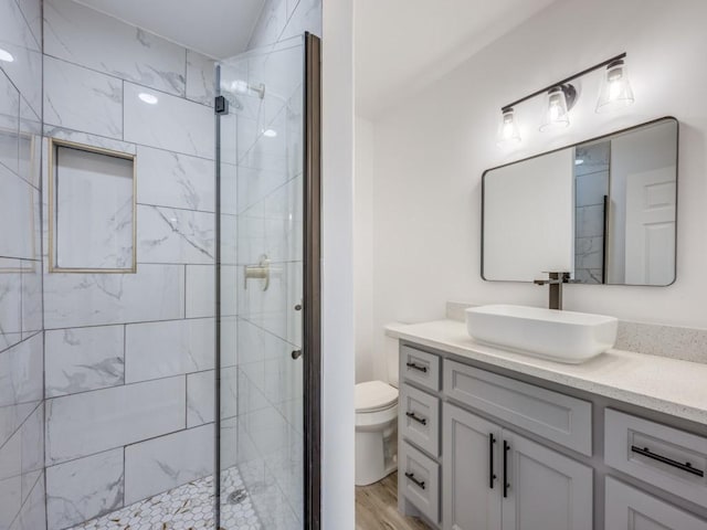 224 High St, Roxton, TX 75477 - full bath with a shower stall, toilet, vanity, and wood finished floors