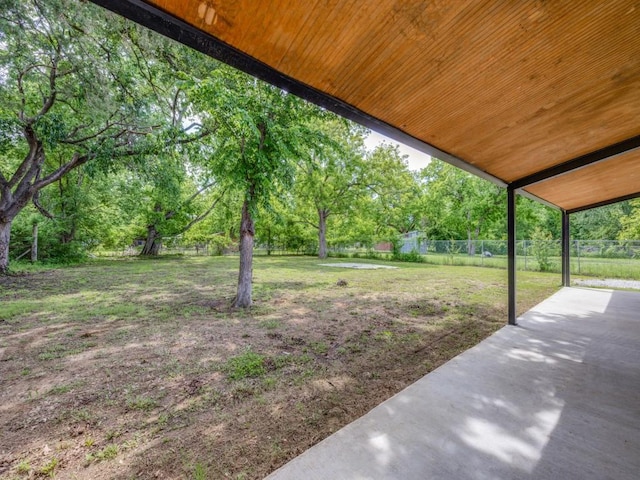 224 High St, Roxton, TX 75477 - view of yard featuring a patio area and view of wooded area