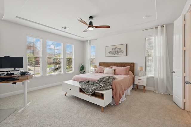 bedroom with light colored carpet, baseboards, and an office area