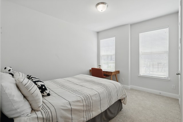 bedroom featuring carpet floors and baseboards