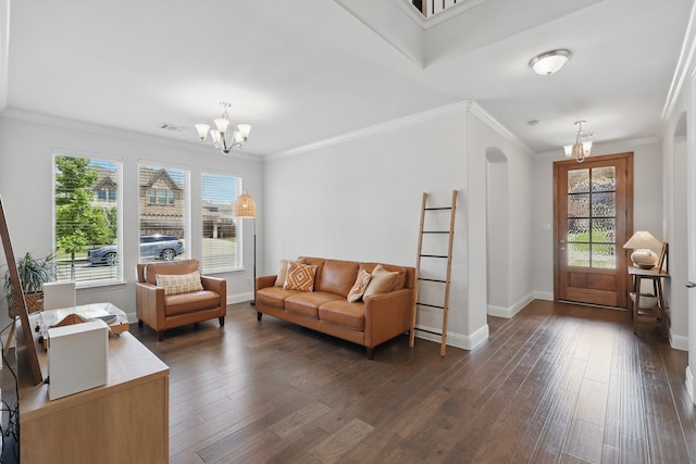 living room featuring a chandelier, dark wood-type flooring, baseboards, and crown molding