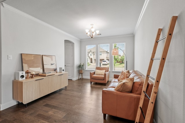 living area with crown molding, arched walkways, dark wood-style floors, a chandelier, and baseboards