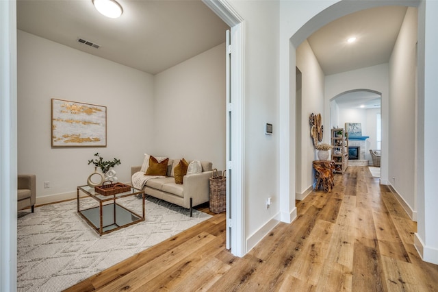 1905 Halkin Rd, Celina, TX 75009 - hall with arched walkways, light wood-style floors, and baseboards