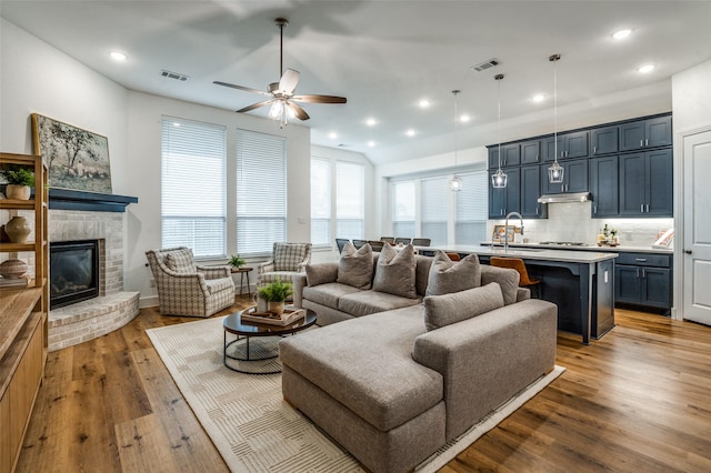 1905 Halkin Rd, Celina, TX 75009 - living area featuring ceiling fan, wood finished floors, a brick fireplace, recessed lighting, and lofted ceiling