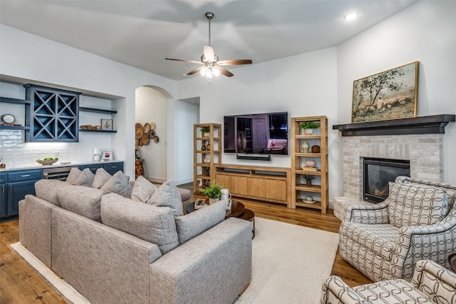 1905 Halkin Rd, Celina, TX 75009 - living room with arched walkways, ceiling fan, wood finished floors, bar area, and recessed lighting