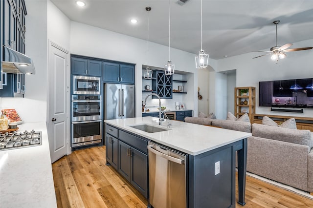 1905 Halkin Rd, Celina, TX 75009 - kitchen featuring a sink, appliances with stainless steel finishes, open floor plan, under cabinet range hood, and light countertops
