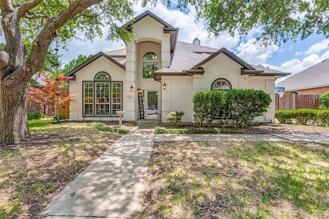 3625 Cottonwood Springs Dr, The Colony, TX 75056 - view of front facade featuring stucco siding, a shingled roof, and fence