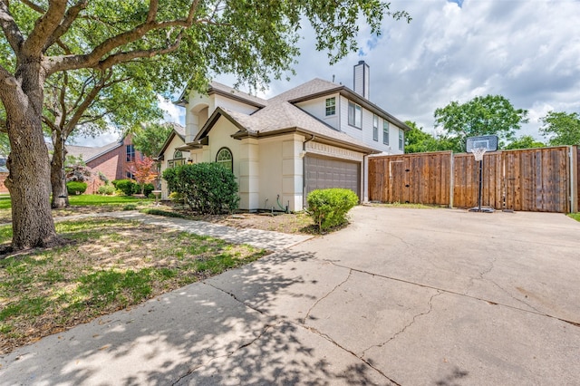 3625 Cottonwood Springs Dr, The Colony, TX 75056 - view of front facade with fence, an attached garage, driveway, a chimney, and a shingled roof