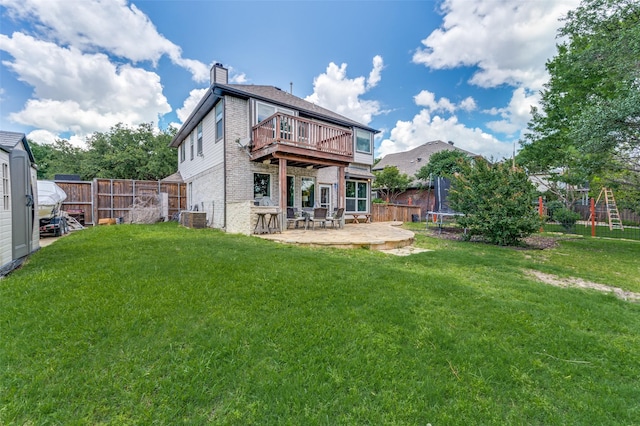 3625 Cottonwood Springs Dr, The Colony, TX 75056 - back of property featuring a trampoline, a patio area, brick siding, a chimney, and central AC