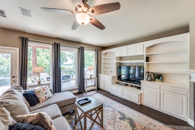 3625 Cottonwood Springs Dr, The Colony, TX 75056 - living area featuring ceiling fan, dark wood-style floors, and a fireplace