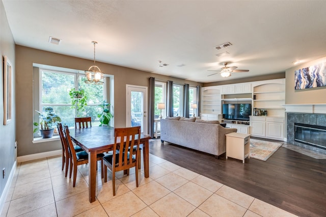 3625 Cottonwood Springs Dr, The Colony, TX 75056 - dining room with plenty of natural light, baseboards, ceiling fan, and a fireplace