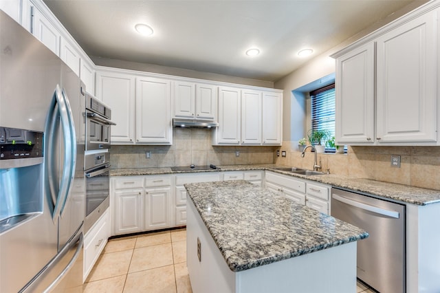 3625 Cottonwood Springs Dr, The Colony, TX 75056 - kitchen with stainless steel appliances, a sink, backsplash, white cabinets, and recessed lighting