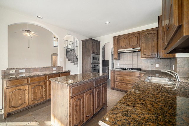 1432 Fence Post Dr, Fort Worth, TX 76052 - kitchen featuring arched walkways, a sink, stainless steel appliances, a ceiling fan, and a kitchen island