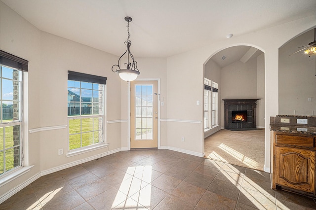 1432 Fence Post Dr, Fort Worth, TX 76052 - unfurnished dining area with a fireplace, a ceiling fan, baseboards, arched walkways, and vaulted ceiling
