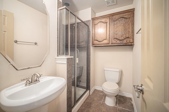 1432 Fence Post Dr, Fort Worth, TX 76052 - bathroom featuring a sink, toilet, a shower stall, and tile patterned floors