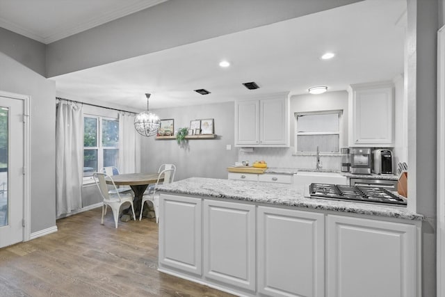 104 Radecke Rd, Krum, TX 76249 - kitchen featuring a sink, white cabinetry, stainless steel gas stovetop, a chandelier, and light wood-style floors