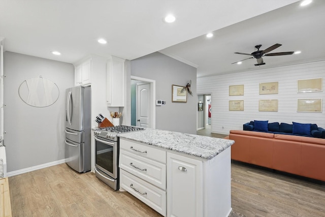 104 Radecke Rd, Krum, TX 76249 - kitchen with appliances with stainless steel finishes, ceiling fan, white cabinetry, light wood-style flooring, and crown molding