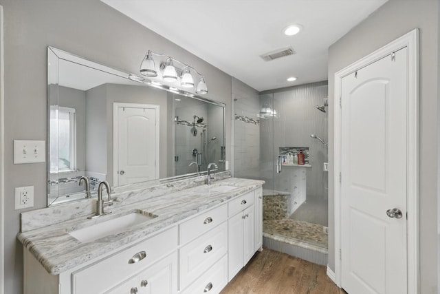 104 Radecke Rd, Krum, TX 76249 - full bathroom with a shower stall, wood finished floors, double vanity, and recessed lighting