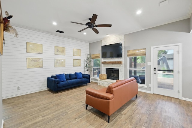 104 Radecke Rd, Krum, TX 76249 - living area featuring light wood-type flooring, a ceiling fan, a fireplace, recessed lighting, and crown molding