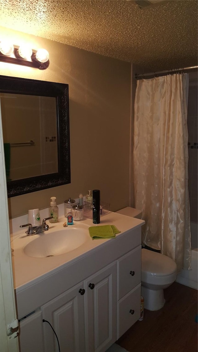 218 N Texas Blvd, Denton, TX 76201 - full bathroom with vanity, toilet, wood finished floors, and shower / bath combination with curtain