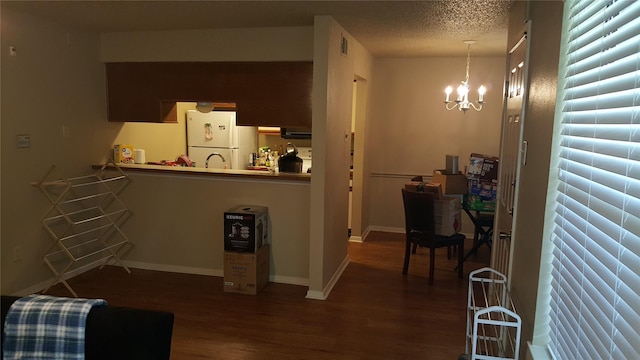 218 N Texas Blvd, Denton, TX 76201 - living area with wood finished floors, a chandelier, baseboards, and a textured ceiling