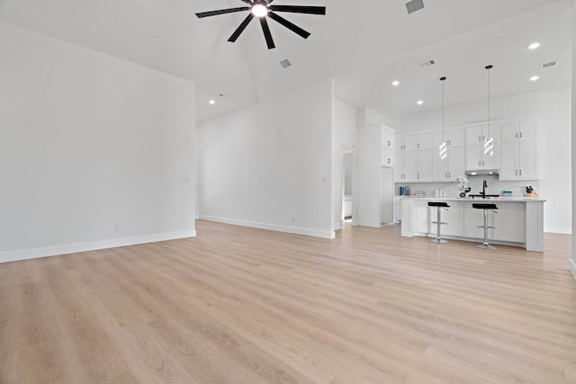 205 Altamesa Blvd, Fort Worth, TX 76134 - unfurnished living room featuring a high ceiling, a ceiling fan, recessed lighting, light wood-style floors, and baseboards