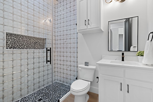205 Altamesa Blvd, Fort Worth, TX 76134 - bathroom featuring a shower stall, vanity, toilet, and wood finished floors