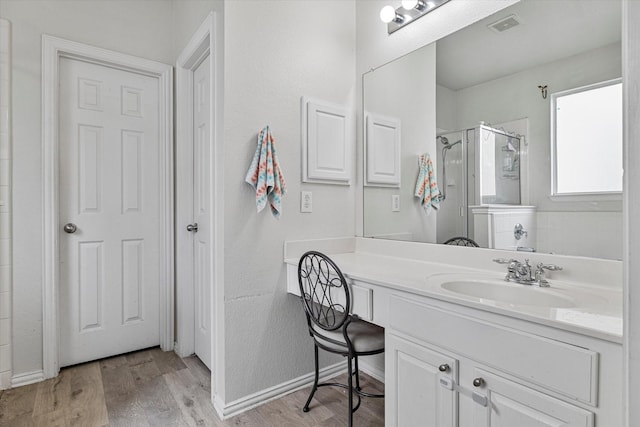 1505 Oakcrest Dr, Providence Village, TX 76227 - bathroom with a shower stall, vanity, wood finished floors, and baseboards