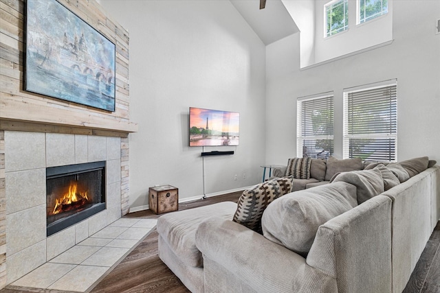 1505 Oakcrest Dr, Providence Village, TX 76227 - living room featuring high vaulted ceiling, a fireplace, wood finished floors, and baseboards