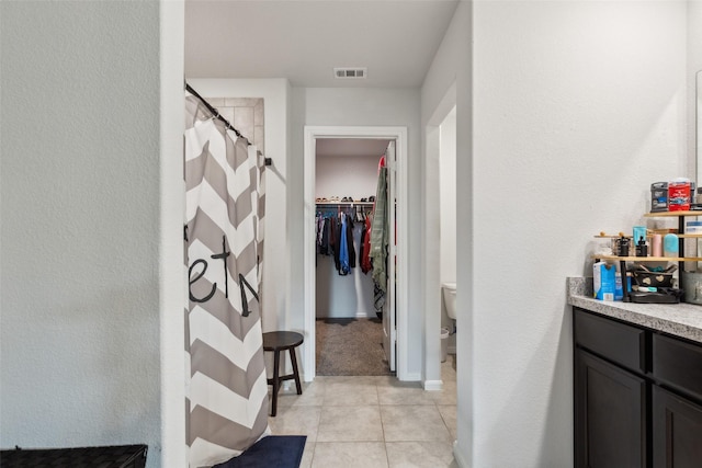16417 Marinette Ct, Justin, TX 76247 - bathroom featuring a spacious closet, tile patterned flooring, a shower with curtain, baseboards, and toilet