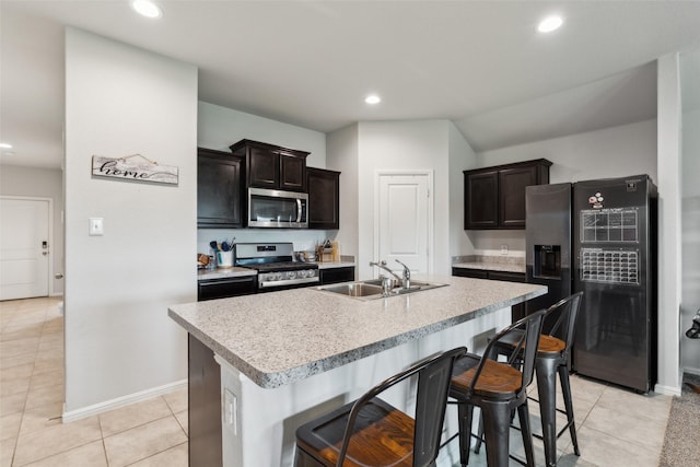 16417 Marinette Ct, Justin, TX 76247 - kitchen featuring stainless steel appliances, a sink, light countertops, light tile patterned flooring, and recessed lighting