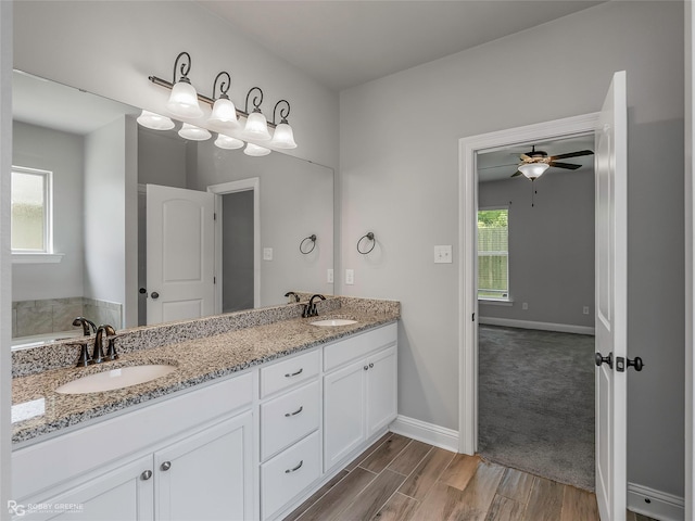 345 Coppice Pl, Bossier City, LA 71111 - full bathroom featuring ceiling fan, double vanity, wood finished floors, and baseboards