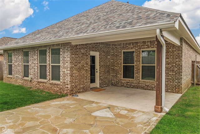 345 Coppice Pl, Bossier City, LA 71111 - back of house featuring a shingled roof, brick siding, a patio area, and fence