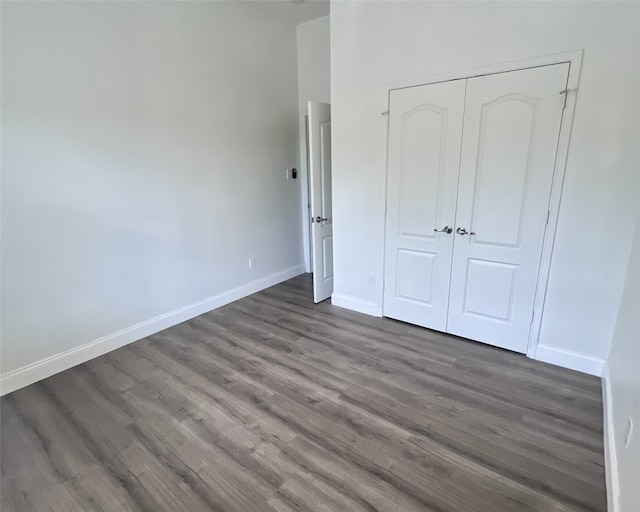 11040 Kinston St, Fort Worth, TX 76179 - unfurnished bedroom featuring dark wood-style floors, baseboards, and a closet