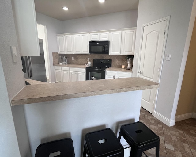 11040 Kinston St, Fort Worth, TX 76179 - kitchen featuring black appliances, tasteful backsplash, a peninsula, white cabinetry, and light countertops