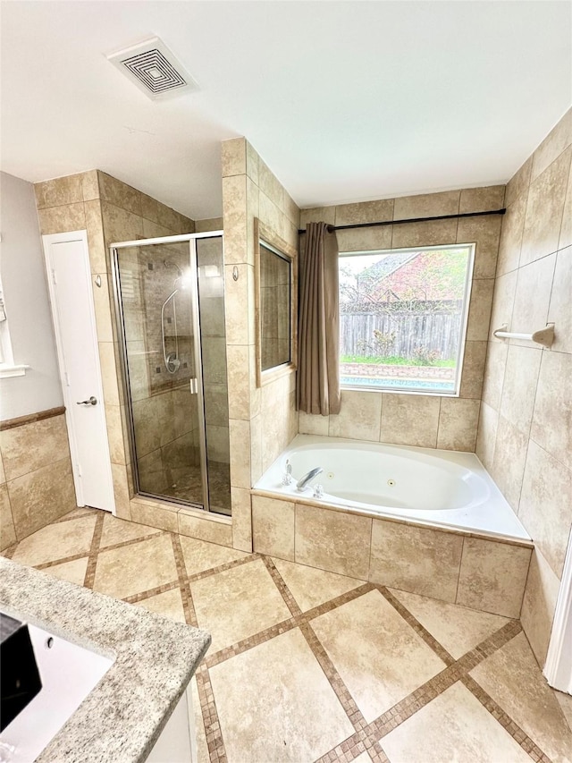 bathroom with a shower stall and a bath