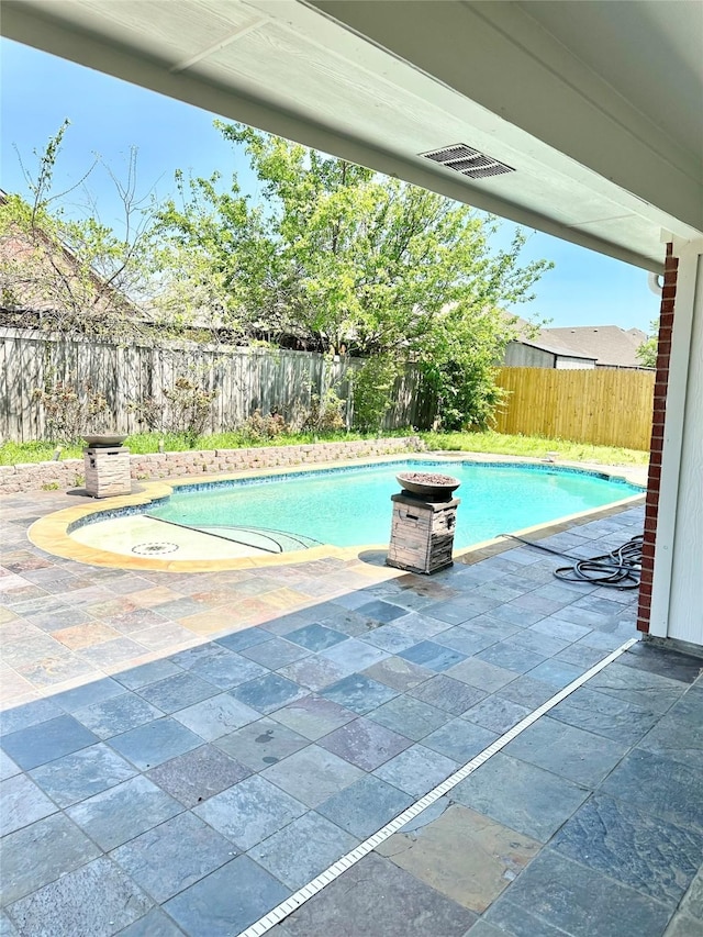 view of pool featuring a patio and a fenced backyard