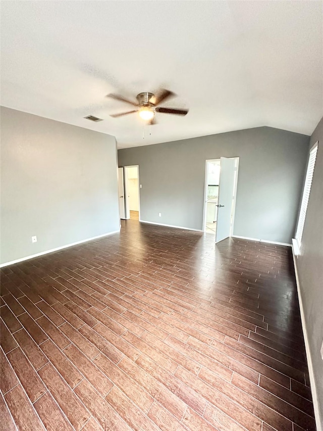 unfurnished room with ceiling fan, wood finished floors, baseboards, and vaulted ceiling
