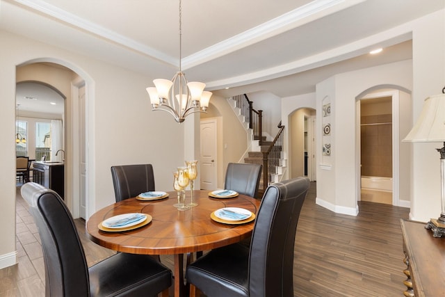 102 Autumn Sage Dr, Wylie, TX 75098 - dining room with arched walkways, baseboards, a chandelier, and wood finished floors