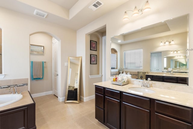 102 Autumn Sage Dr, Wylie, TX 75098 - bathroom with a tray ceiling, a garden tub, tile patterned flooring, and baseboards
