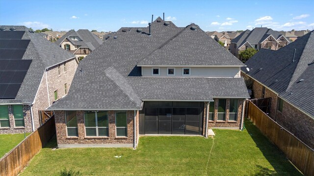 102 Autumn Sage Dr, Wylie, TX 75098 - rear view of property featuring a shingled roof, brick siding, a residential view, and a sunroom