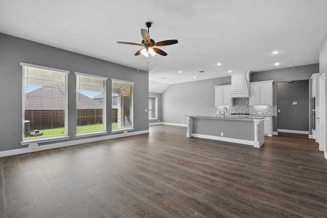 300 Navo Rd, Little Elm, TX 75068 - unfurnished living room featuring a ceiling fan, baseboards, dark wood-type flooring, recessed lighting, and a sink