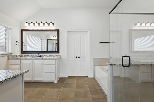 300 Navo Rd, Little Elm, TX 75068 - bathroom with tile patterned flooring, a shower stall, vaulted ceiling, a bath, and vanity