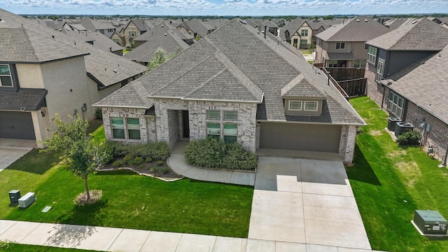300 Navo Rd, Little Elm, TX 75068 - view of front of home with a residential view, brick siding, a garage, roof with shingles, and central AC unit
