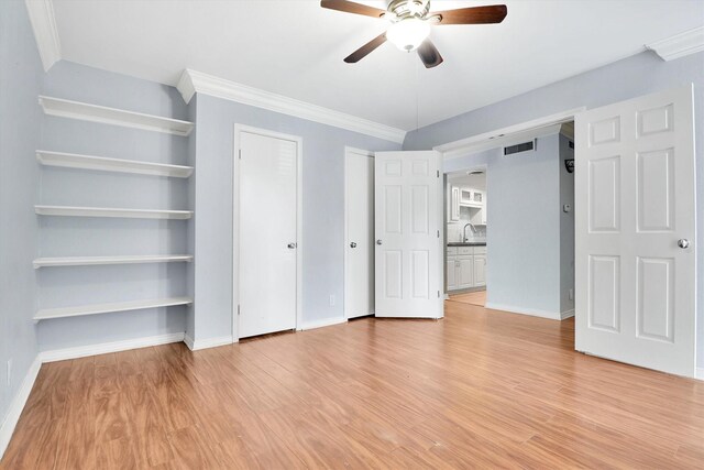 534 E Ave J Unit A, Grand Prairie, TX 75050 - unfurnished bedroom with light wood-style floors, a sink, baseboards, and ornamental molding