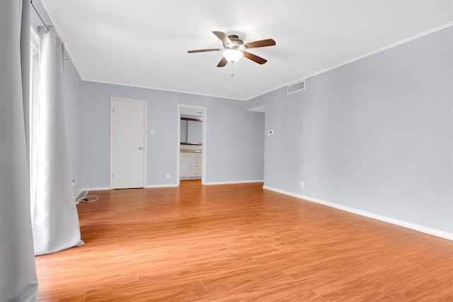 534 E Ave J Unit A, Grand Prairie, TX 75050 - unfurnished room featuring ceiling fan, baseboards, ornamental molding, and light wood-style flooring