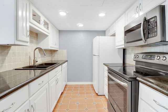 534 E Ave J Unit A, Grand Prairie, TX 75050 - kitchen featuring appliances with stainless steel finishes, a sink, dark countertops, white cabinets, and tasteful backsplash